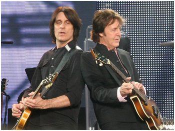 Rusty Anderson onstage with Paul McCartney.